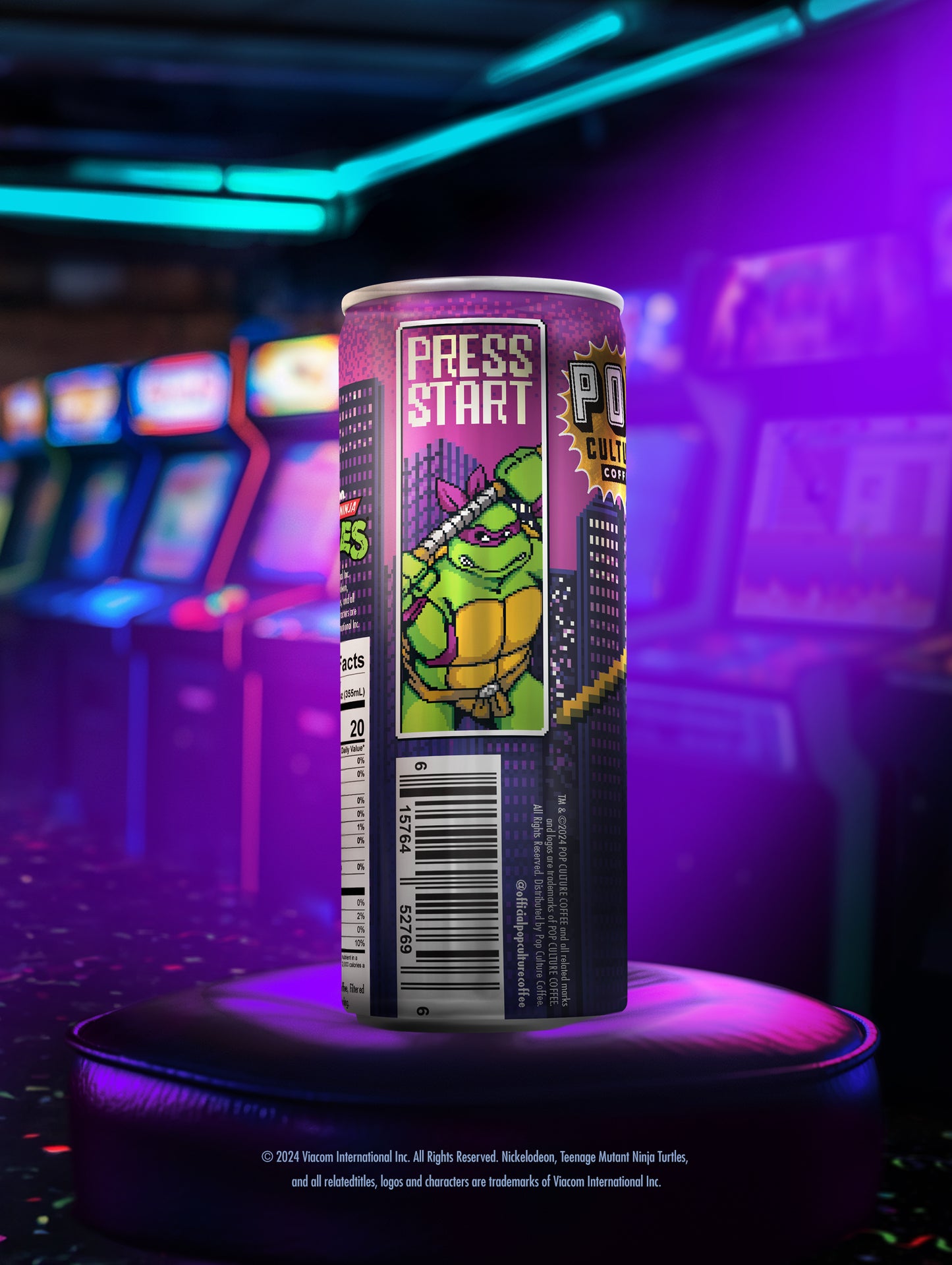A close-up of a single can showing the retro arcade-style artwork of Donatello with his bo staff.