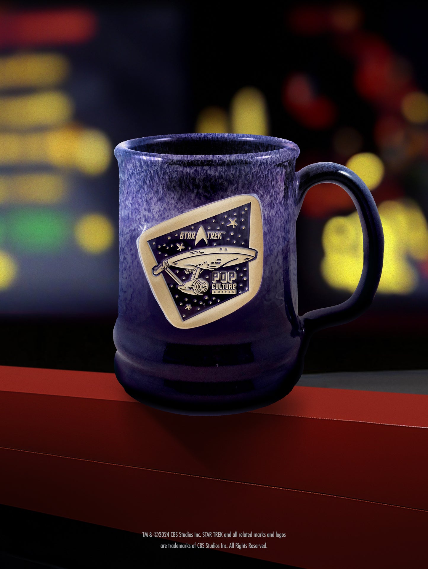The handthrown stoneware Star Trek: Enterprise mug, featuring a unique midnight plum glaze.