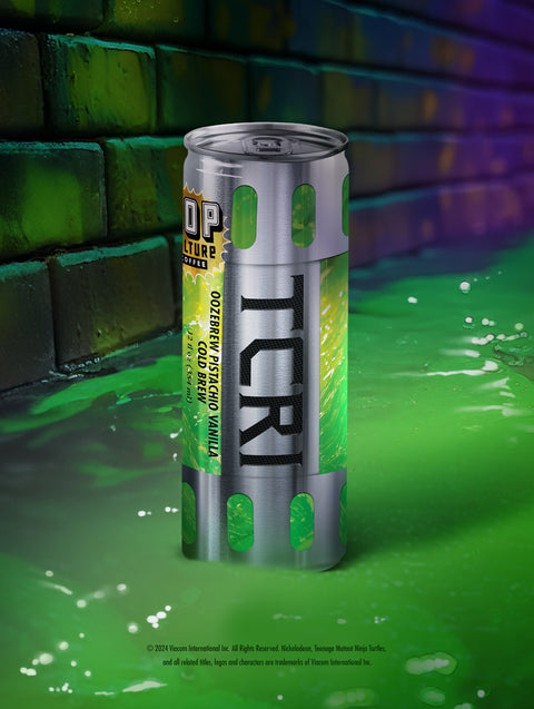 A close-up of a single can of OozeBrew, showing the green ooze design and the TCRI logo.