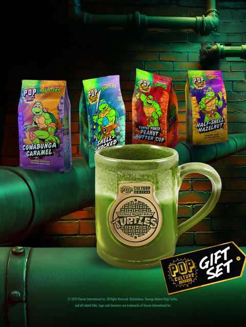 The Teenage Mutant Ninja Turtles Shelltastic Gift Set, showing the four coffee bags arranged around the exclusive Manhole Cover Mug.