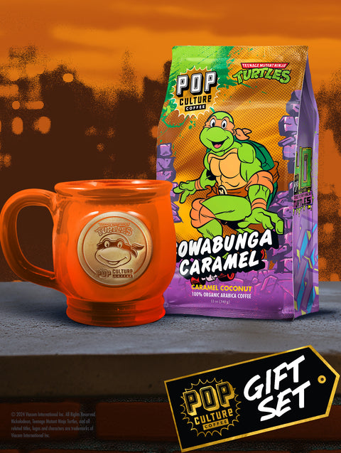 The Teenage Mutant Ninja Turtles Michelangelo gift set, showing the orange handthrown mug alongside a bag of Cowabunga Caramel Coconut coffee.
