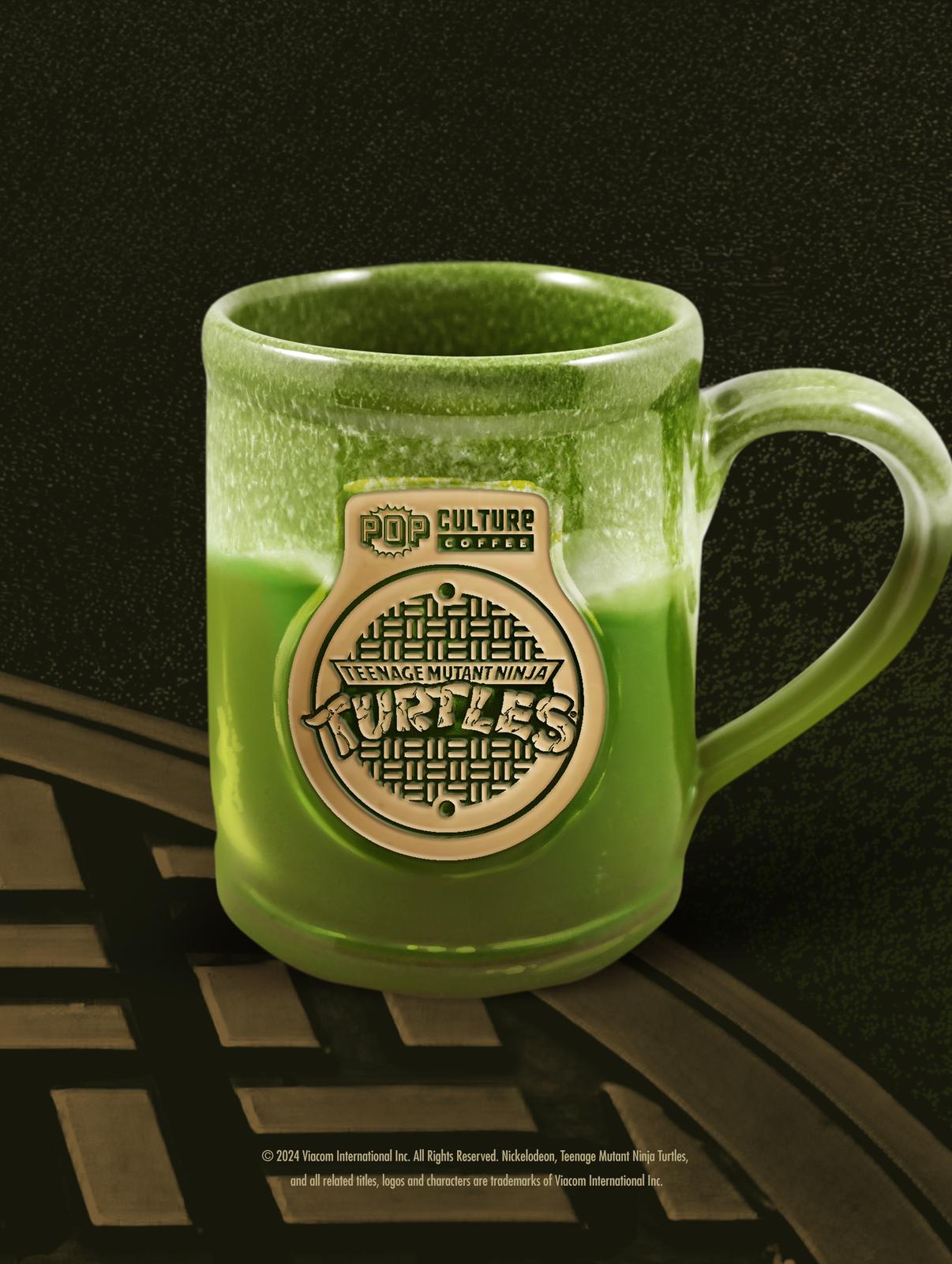 The exclusive 40th Anniversary Teenage Mutant Ninja Turtles Manhole Cover Mug by Deneen Pottery.