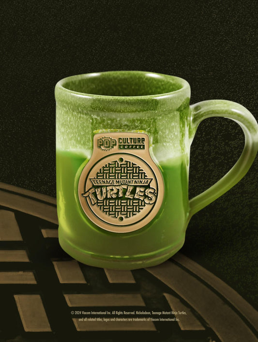 The exclusive 40th Anniversary Teenage Mutant Ninja Turtles Manhole Cover Mug by Deneen Pottery.