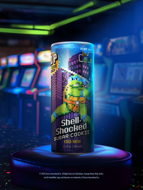 A close-up of a single can showing the retro arcade-style artwork of Leonardo with his katanas at the ready.