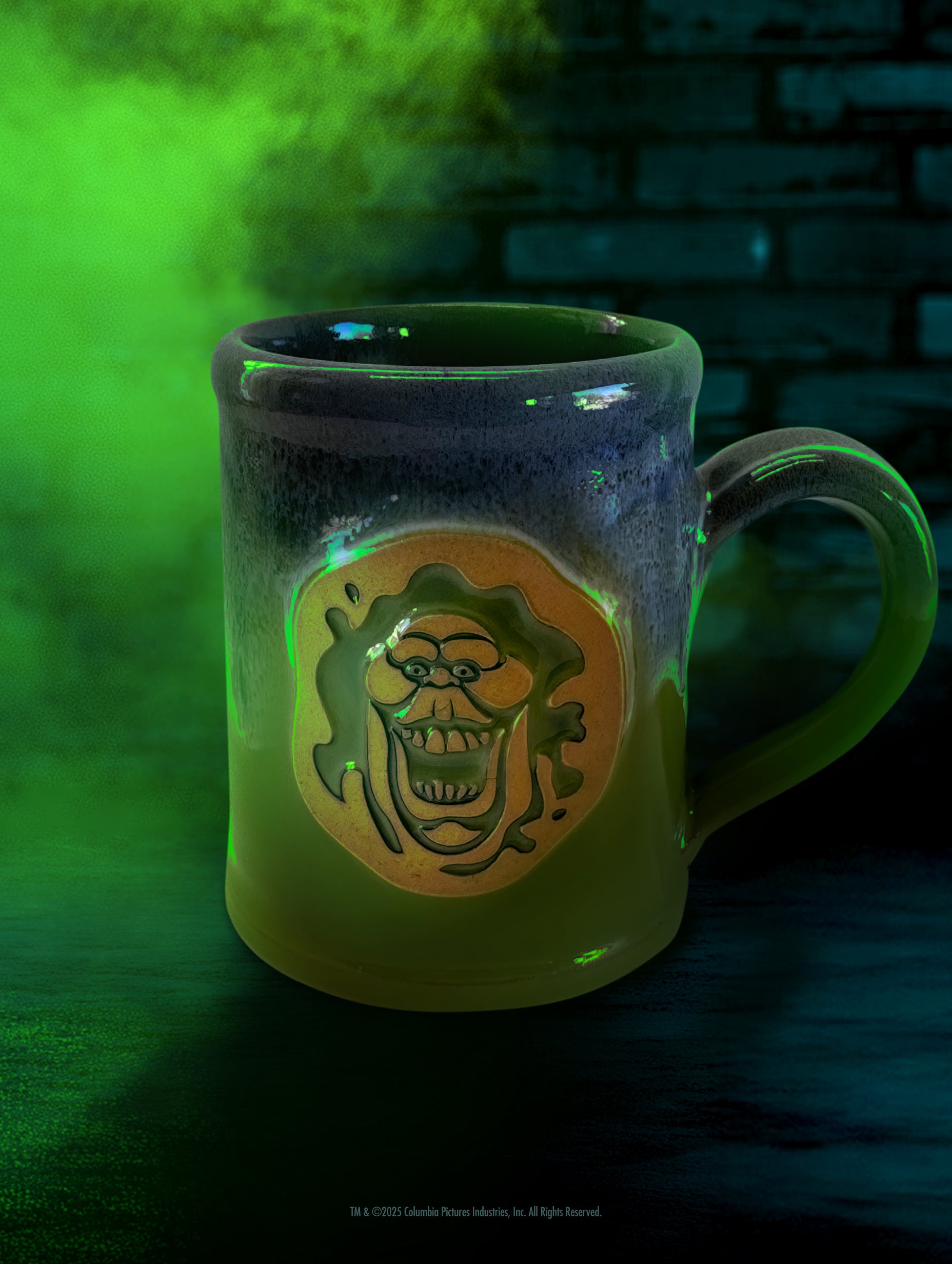 The official Ghostbusters Slimer handthrown mug by Deneen Pottery, featuring a gooey green glaze.
